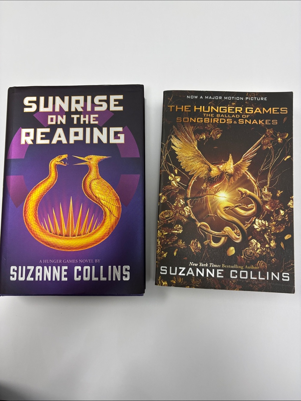 Two Suzanne Collins books. Sunrise on the Reaping and The Ballad of the Songbird